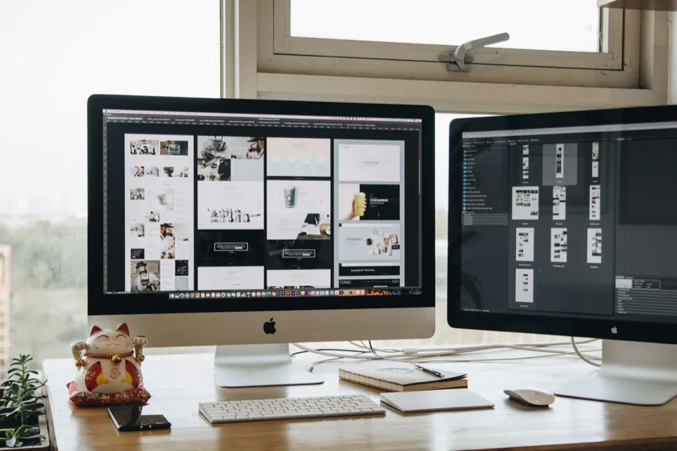 Two desktop screens filled with page layouts open in a design tool.